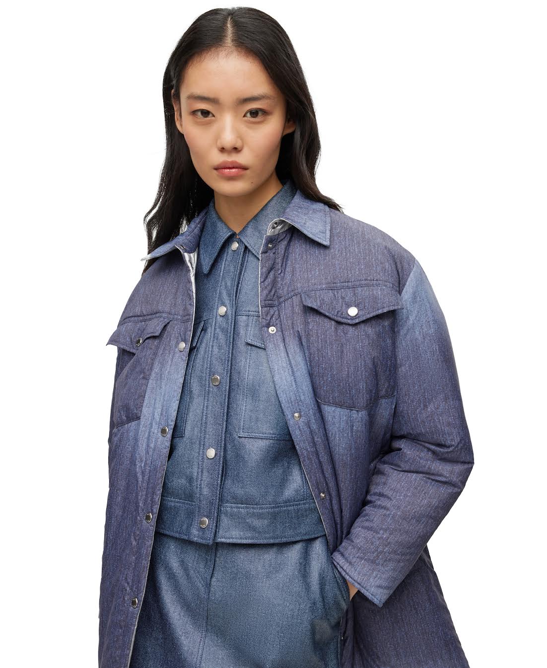 A female model wearing a reversible denim effect and silver-tone quilting jacket by HUGO BOSS.