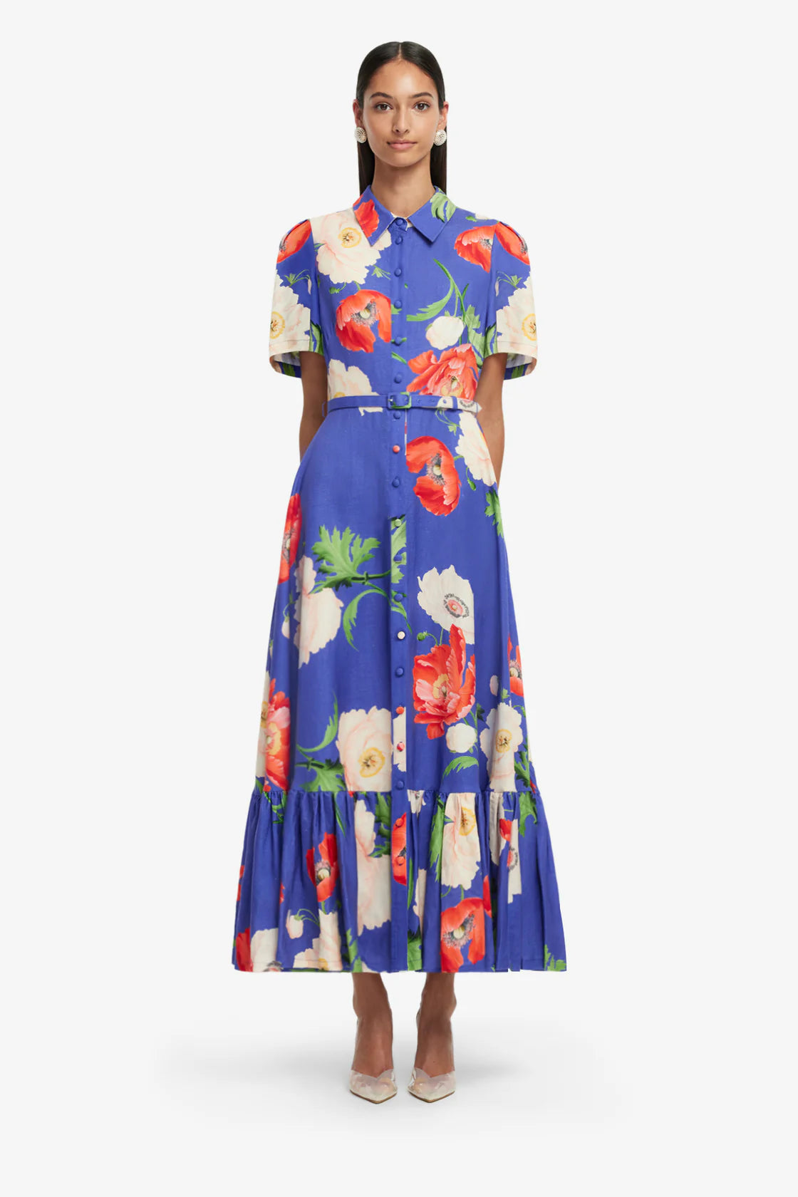 Woman wearing a colorful floral dress on a white background