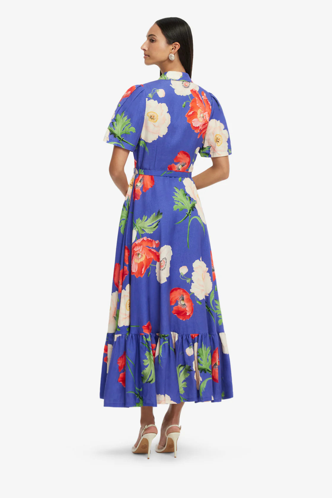 Woman wearing a blue floral dress on a white background