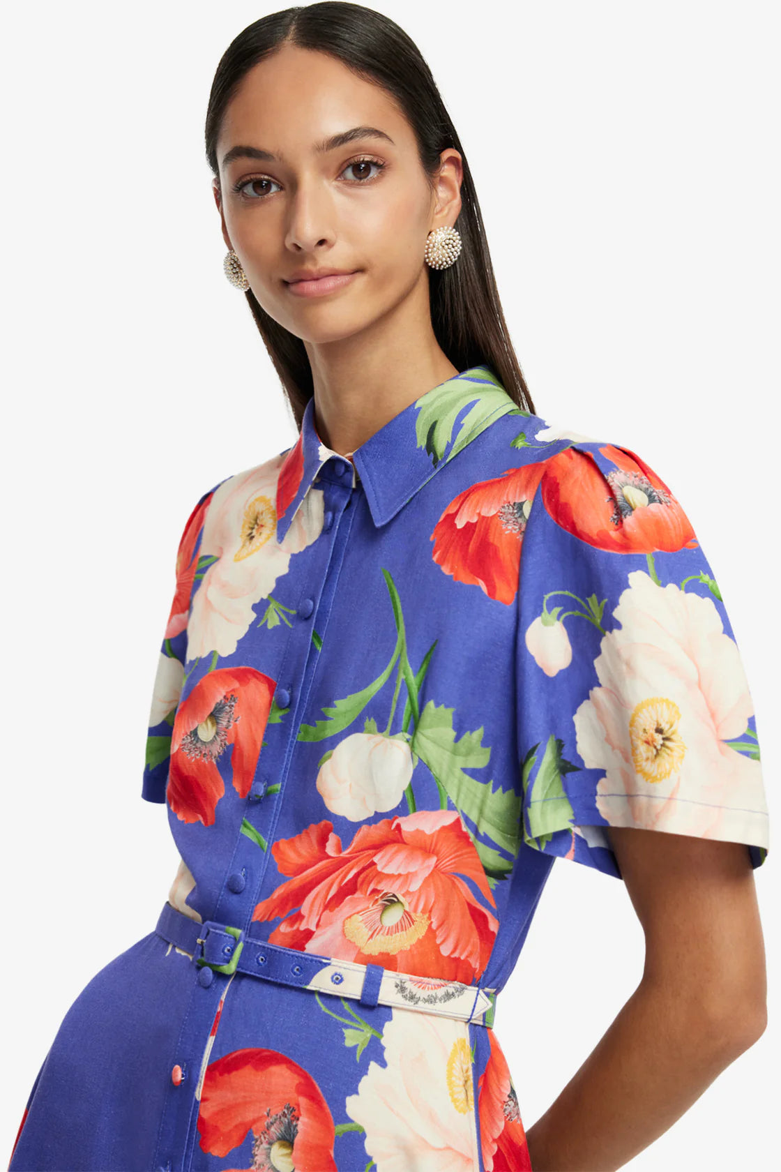 Woman wearing a blue floral shirt with a white background