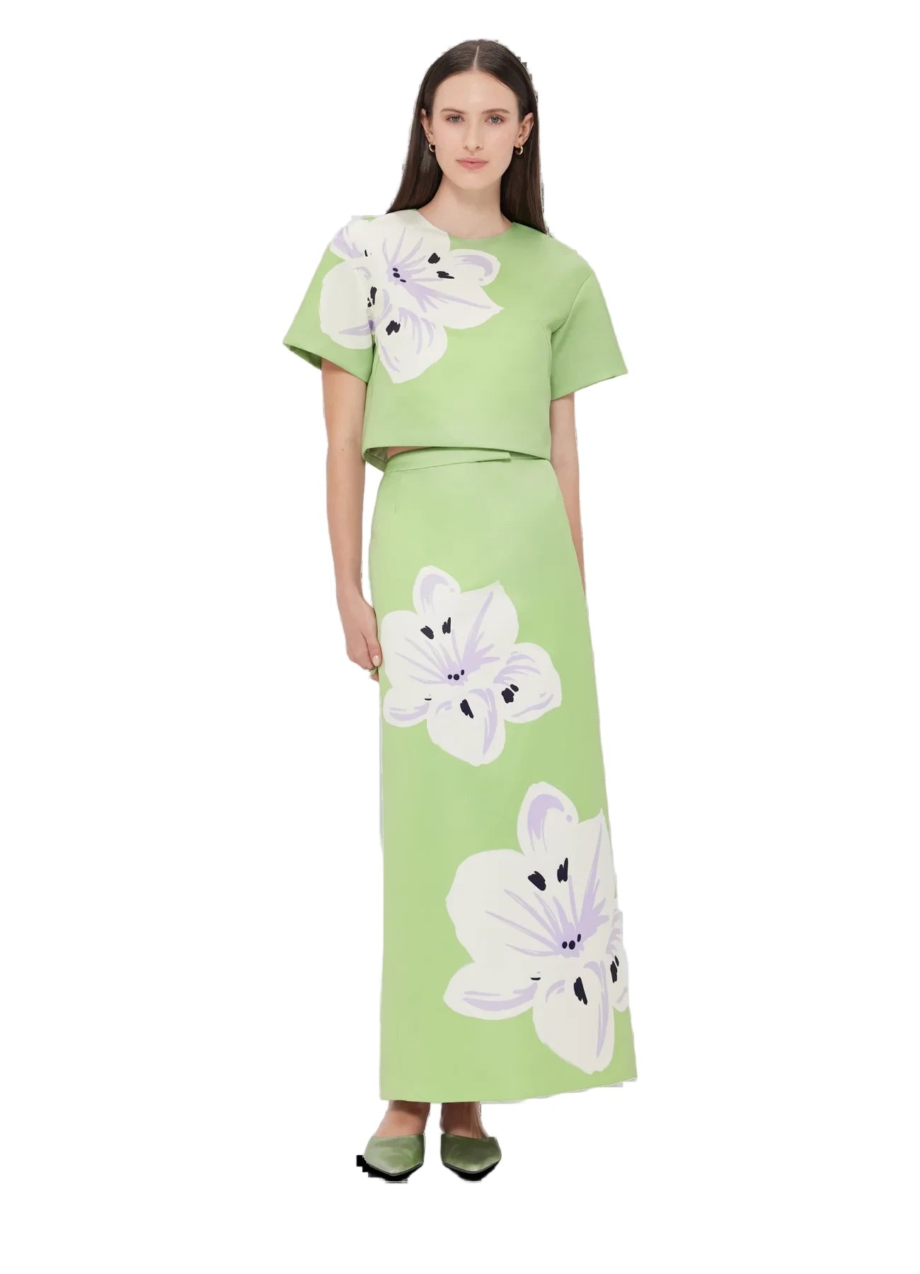 A model wearing a green maxi skirt with a large white and purple floral print.