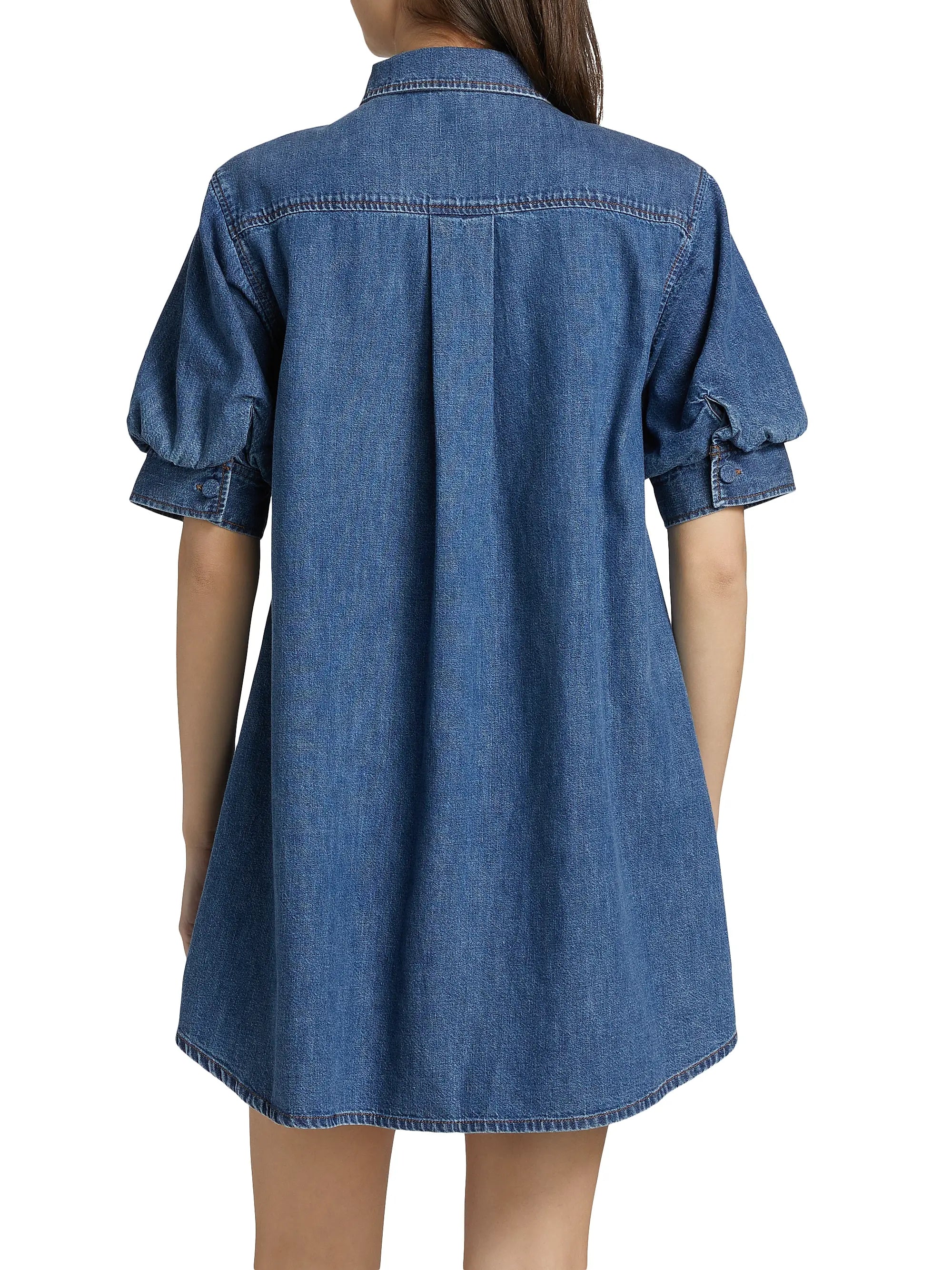 Blue denim dress worn by a person on a white background