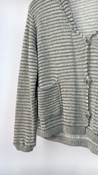 Close-up of a textured gray cardigan on a white background