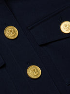 Close-up of a navy blue fabric with gold buttons