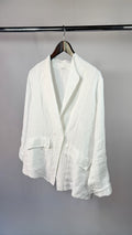 White blazer on a hanger against a plain background