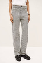 Person wearing gray and white striped pants on a white background