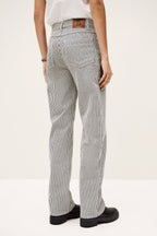 Person wearing gray pinstripe pants on a white background