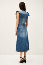 Woman wearing a denim dress on a white background