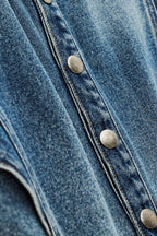 Close-up of a blue denim jacket with button details