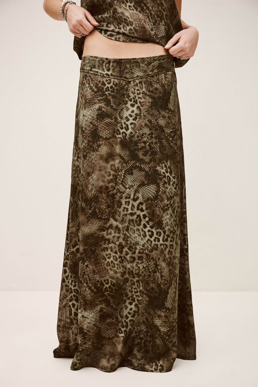 Long animal print skirt worn by a person on a plain background