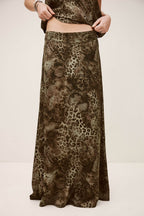 Long animal print skirt worn by a person on a plain background