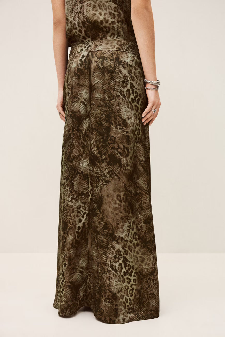 Long animal print dress worn by a person on a plain background
