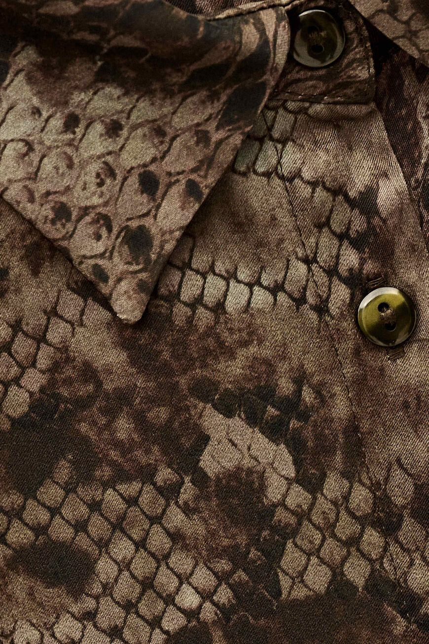 Close-up of a textured brown fabric with a pattern resembling scales.