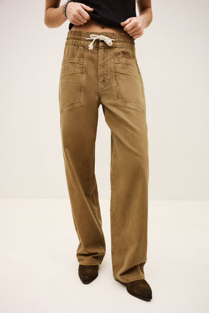 Brown pants worn by a person on a white background
