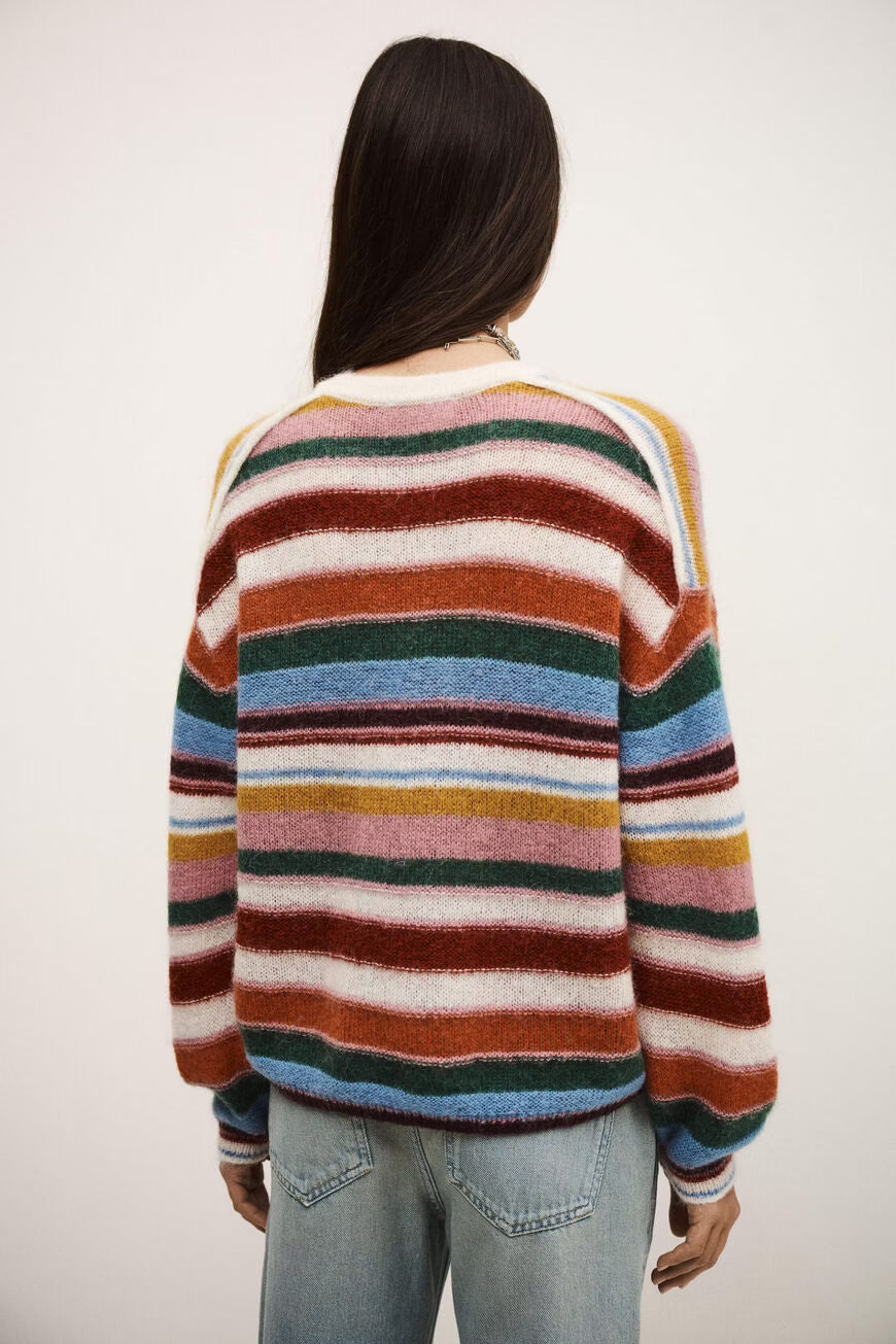 Person wearing a multicolored striped sweater against a white background
