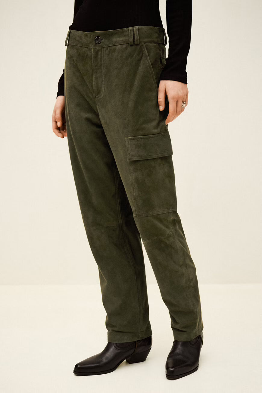 Person wearing olive green cargo pants on a white background