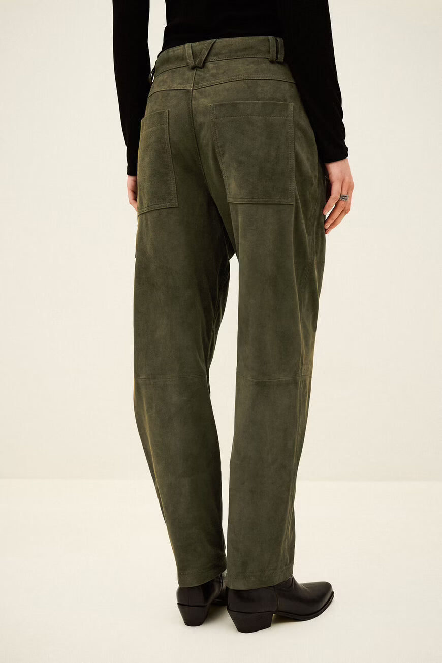 Person wearing olive green pants on a white background