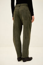 Person wearing olive green pants on a white background