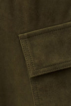 Close-up of a green fabric pocket on a coat