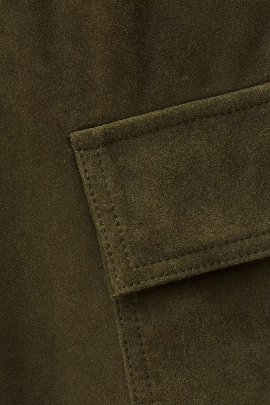 Close-up of a green fabric pocket on a coat