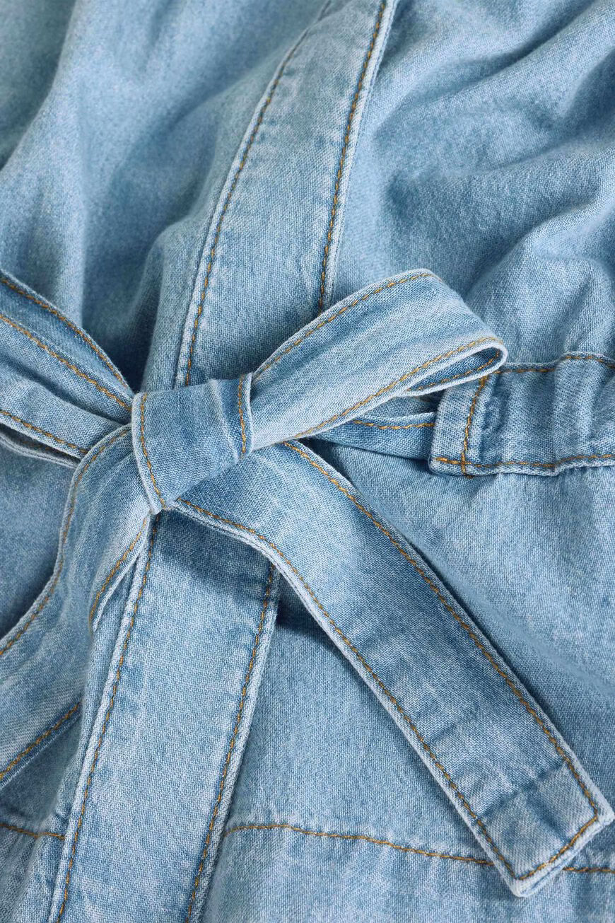 Close-up of a denim robe with a tie detail