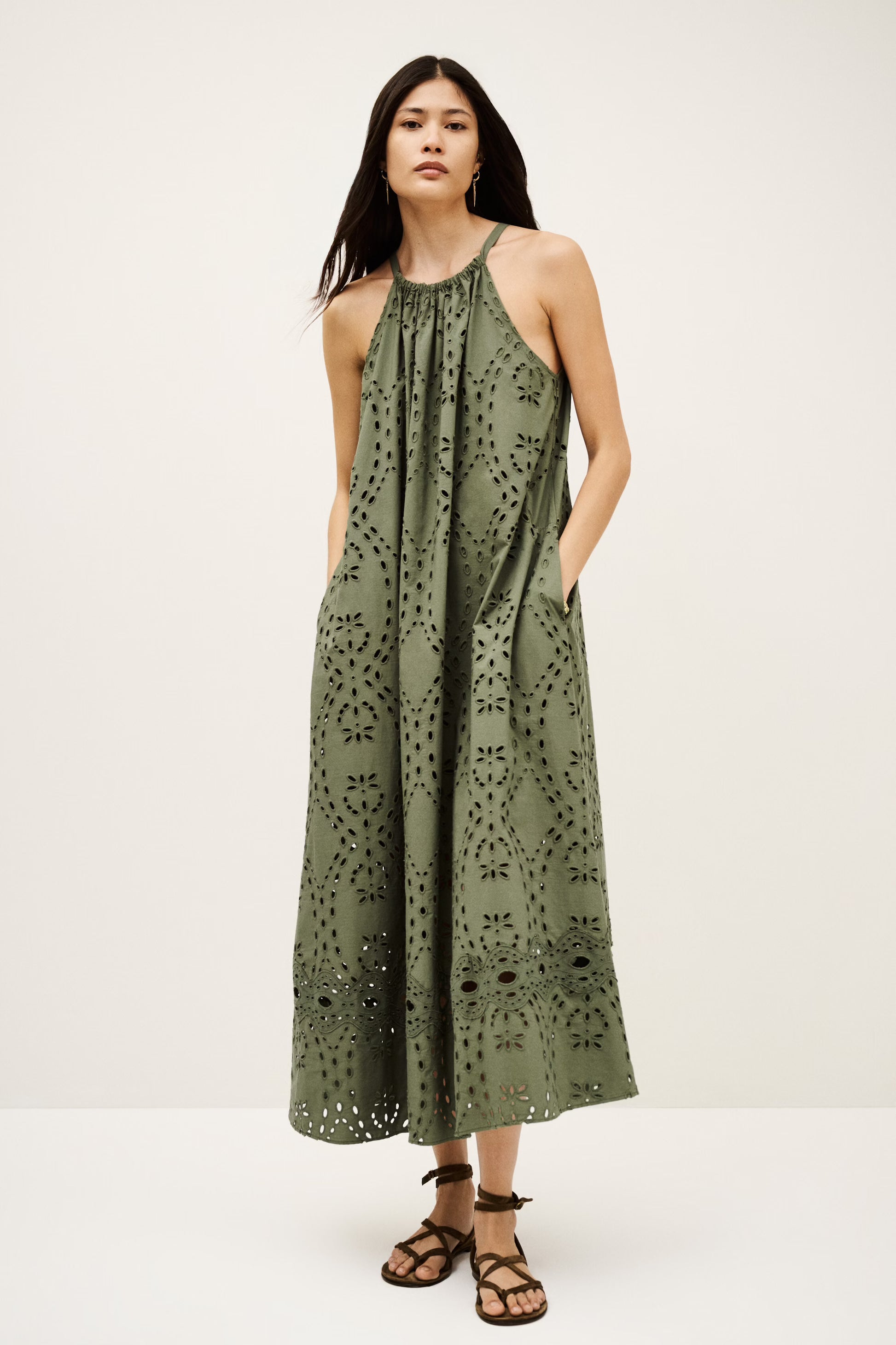 Woman wearing a green ba&sh bonie dress on a white background
