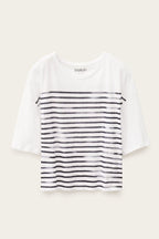 White t-shirt with black horizontal stripes on a beige background