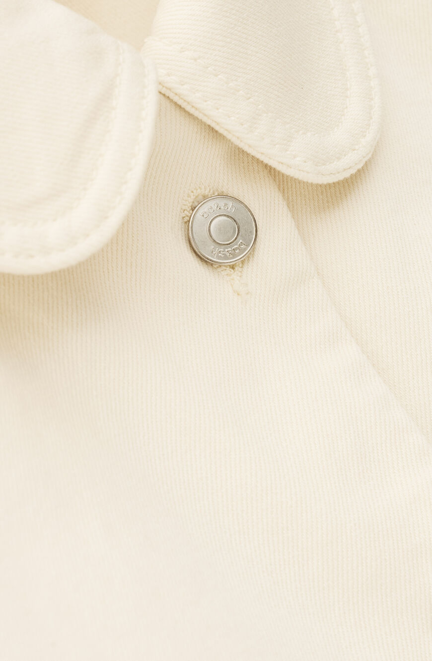Close-up of a button on a beige fabric background