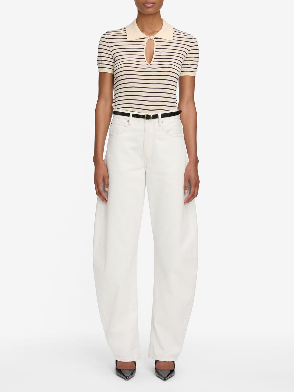 Person wearing a striped shirt and white pants on a white background