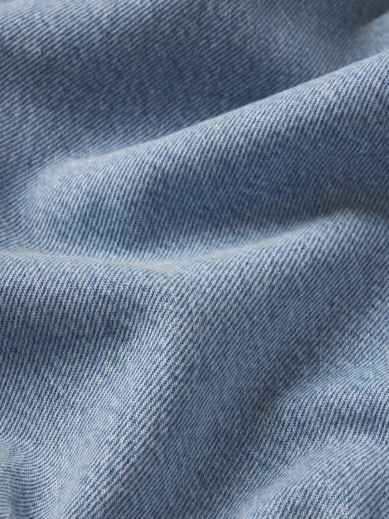 Close-up of blue denim fabric with visible texture