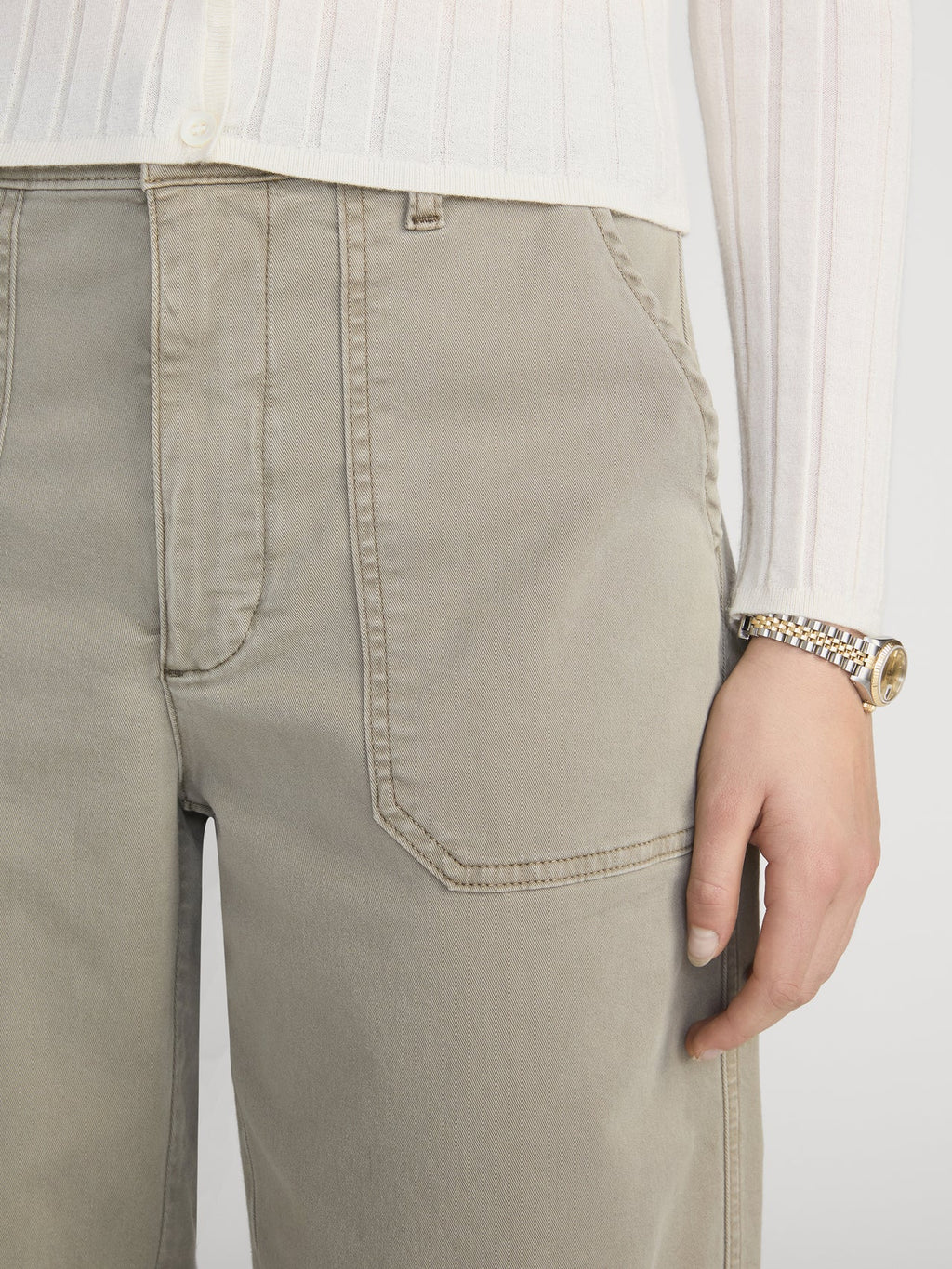 Beige pants worn by a person with a white background
