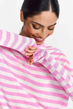 Woman wearing a rich and royal pink and white striped shirt against a plain background shop online muse boutique hawthorn