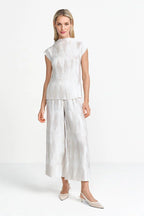 Woman wearing a rich and royal pearl white outfit with a plain background muse boutique hawthorn shop online