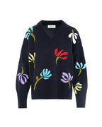 dark navy  sweater with colorful floral patterns on a white background