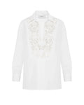 White blouse with lace detailing on a white background
