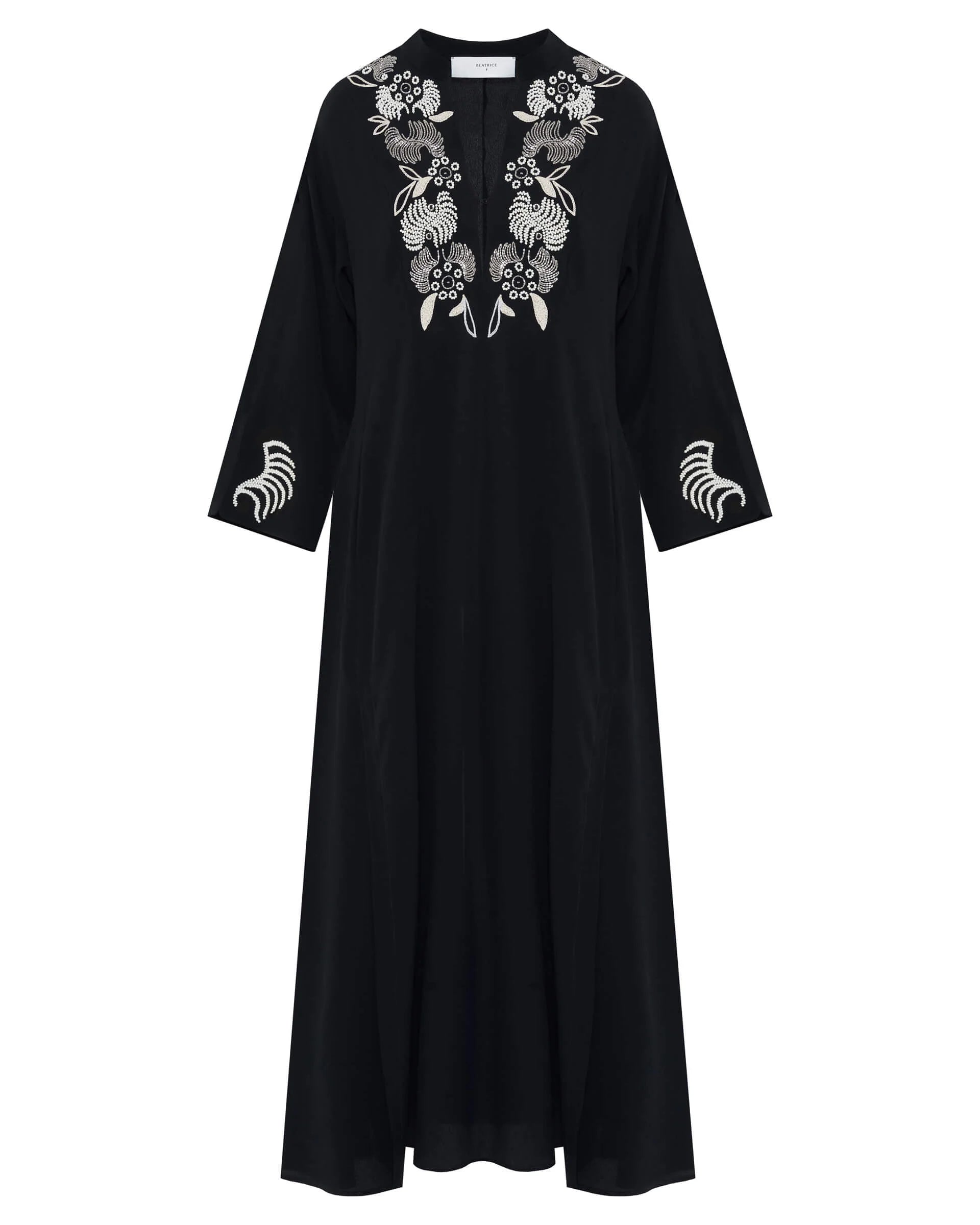 Black dress with floral embroidery on a white background
