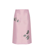 Pink skirt with floral embellishments on a white background