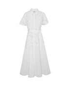 A white short-sleeve midi dress with a pointed collar, button front, and delicate floral embroidery, shown against a plain white background.