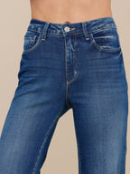 Blue jeans worn by a person on a beige background