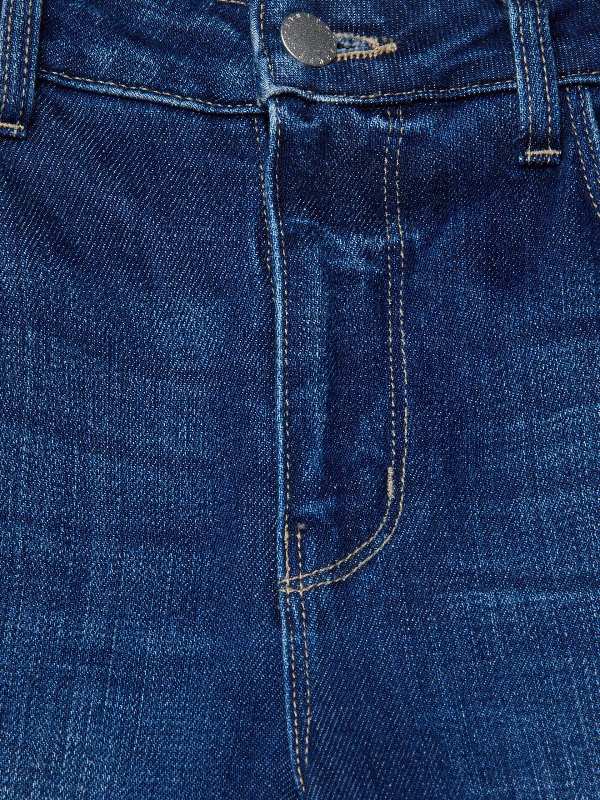 Close-up of blue denim fabric with stitching details