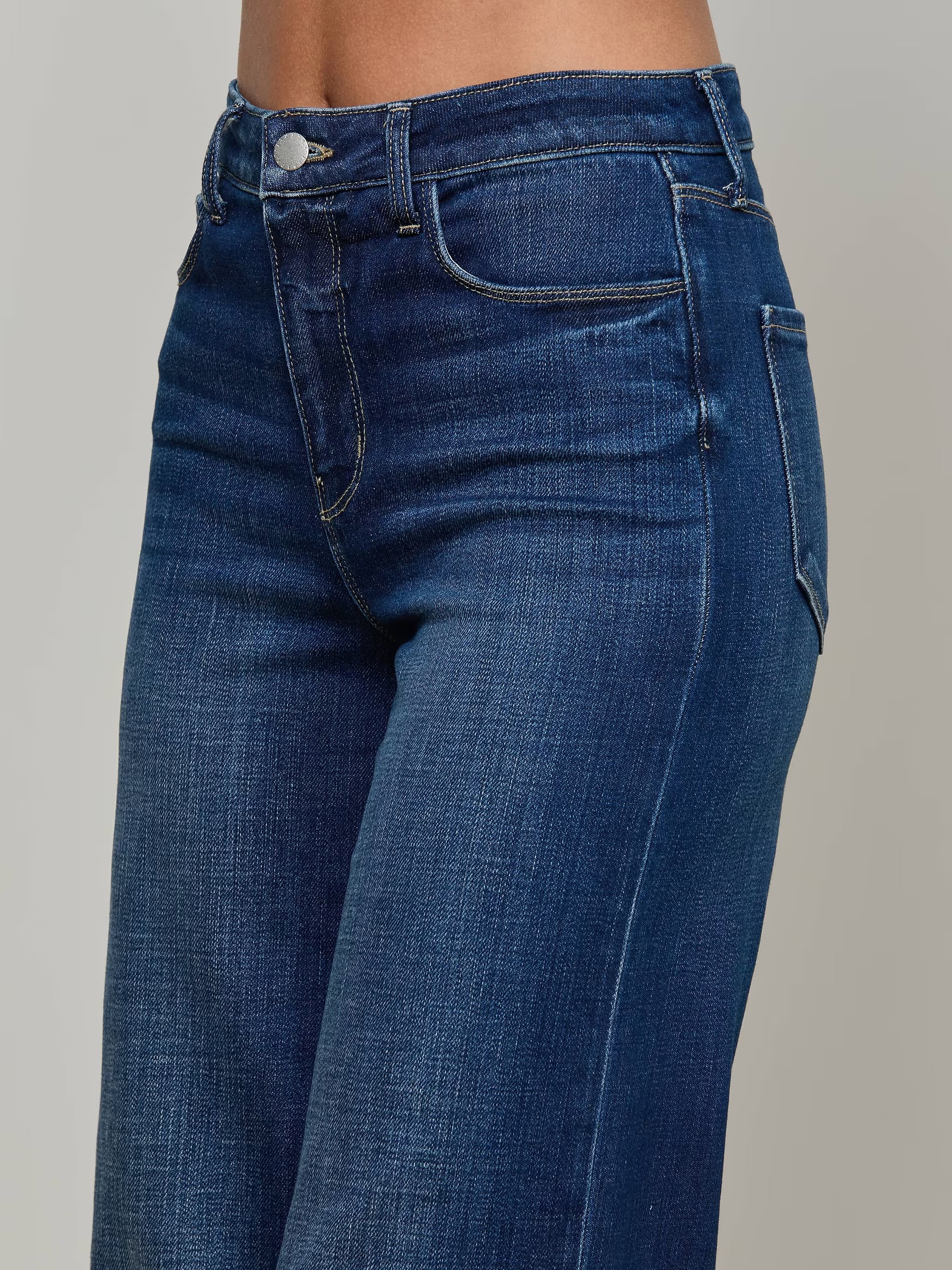 Close-up of blue jeans on a gray background