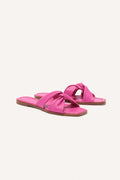 A pair of pink flat sandals with a cushioned foam sole and leather twist detail on the upper.