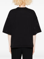 Black oversized t-shirt with studded details on a plain background