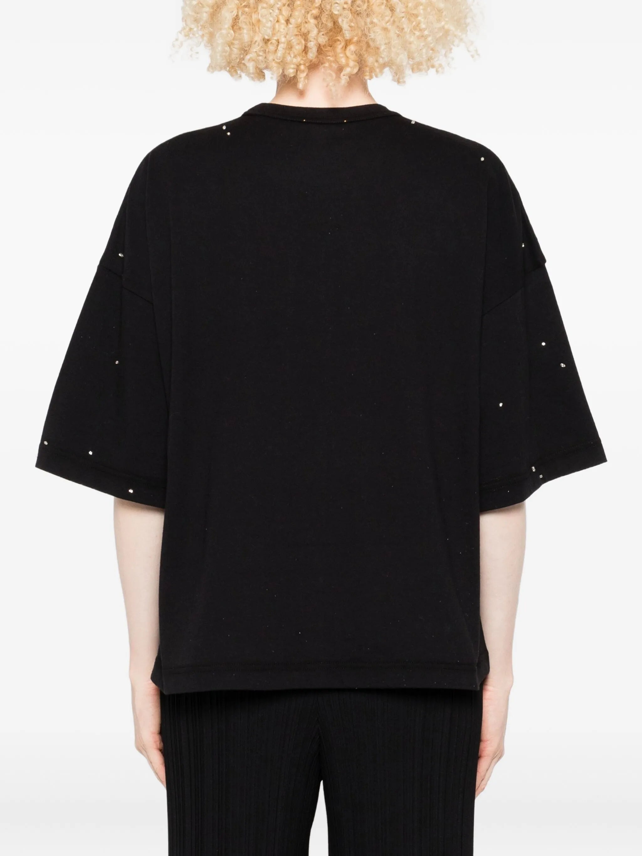 Black oversized t-shirt with studded details on a plain background