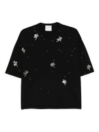 Black t-shirt with white floral patterns on a white background