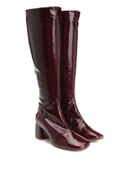 Pair of burgundy knee-high boots on a white background