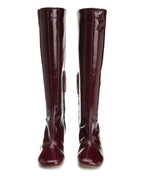 Pair of burgundy knee-high boots on a white background