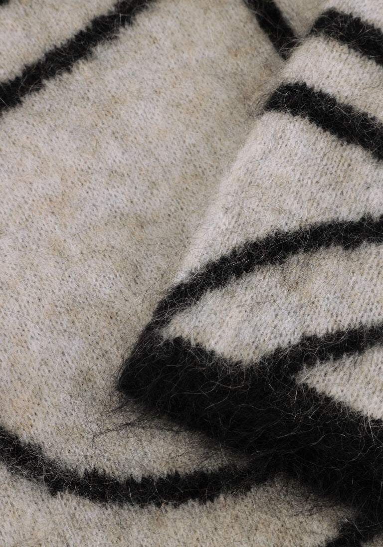 Close-up of a textured fabric with black and white stripes.