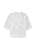 White short-sleeve blouse with floral applique embroidery on the back, shown against a plain white background.