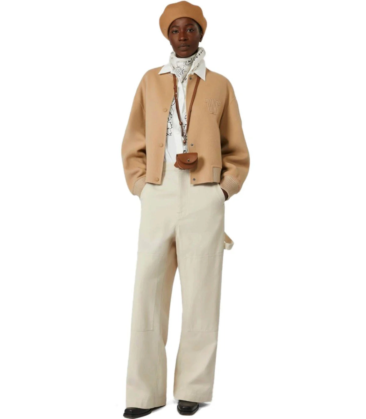 Person wearing a beige jacket, white pants, and a brown hat on a white background